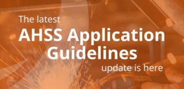 New AHSS Guideline Update Graphic on Orange Background Over a Photo of Automotive Welding