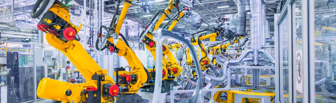Image of automotive structures in a vehicle assembly plant with robotic arms