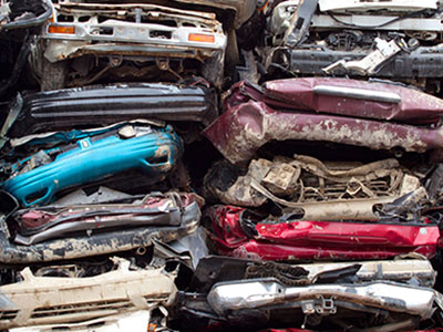 Flattened vehicles on top of each other for recycling